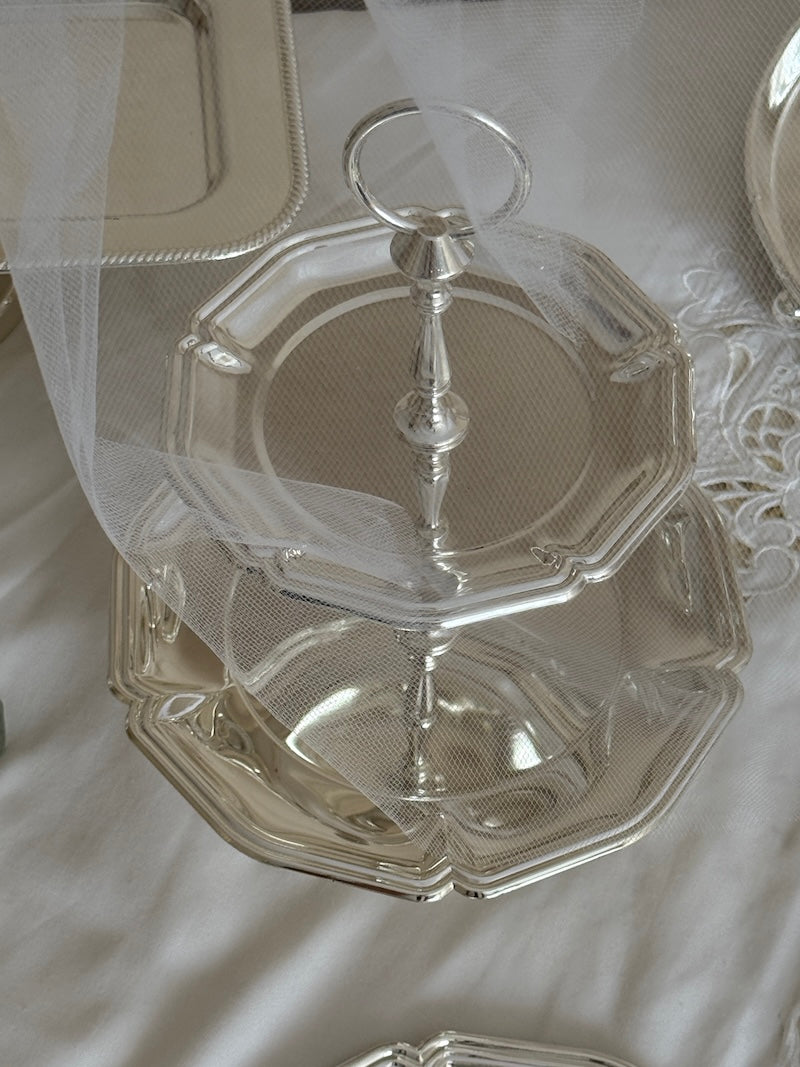 Silver cake stand on a white lace tablecloth